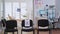 Empty waiting room with signs on chairs respecting social distance