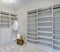 Empty walk-in closet with open shelves