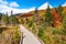 Empty walkway through wetland in a beautiful mountain scenery and blue sky