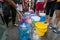 Empty water buckets waiting for fresh water from emergency mobile tank truck