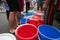 Empty water buckets waiting for fresh water from emergency mobile tank truck