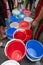 Empty water buckets waiting for fresh water from emergency mobile tank truck