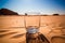 Empty water glass in desert sand drought climate change global warming concept