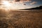 Empty waved sand near lake in summer evening in Russia