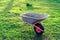 Empty wheel barrow in garden, toned