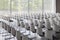 Empty white chairs in contemporary conference hall with