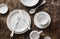 Empty white dishware served wooden table, top view.