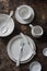 Empty white dishware served wooden table, top view.