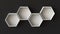 Empty white hexagons shelves on blank wall background. 3D rendering.