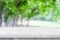 Empty white marble table over blur green nature park background, product display montage