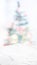Empty white marble table top with abstract Christmas tree decor string light blur background,Holiday backdrop,Mockup vertical