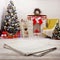 Empty white napkin on white wooden desk top view. Festive sparkling Christmas interiors background