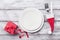 Empty white plate and decoration on wooden rustic table top view. Christmas table setting concept.