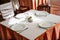 Empty white plate in a formal table setting on a table set