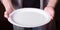 Empty white plate in the hands of have human