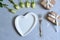 empty white plate with hearts on Ultimate Gray background with white roses and fork.