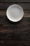 Empty white plate on a wooden loft table