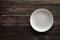 Empty white plate on a wooden loft table