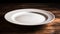 Empty white plate on wooden table