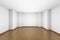 Empty white room with brown hardwood parquet floor