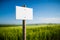 Empty white signboard with vintage wooden post and beautiful nature in the background