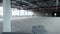 Empty white space for company in new building. Stock footage. Open, empty warehouse with bare walls and steel beams