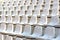 Empty white stadium stand rows with sunlight