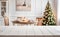 Empty white table with christmas dining room and tree in the background with copy space