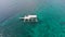 Empty white tourist boat in a blue sea or ocean with calm clear blue water. View from above