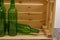 Empty wine bottles in a wooden box on the table. Home winemaking