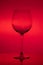 Empty wine glass on red background, empty wineglass