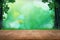 Empty wood plank table top with blur park green nature background