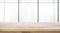 Empty of wood table top on blur big window office background.