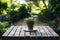 Empty wood table top with blur outdoor garden background