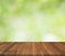 Empty wood table top on blurred abstract green background