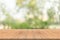 Empty wood table top on nature green blurred background at garden,space for montage show products