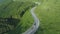 Empty wood transportation truck drving on curvy forest mountain road