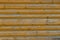 the empty wooden background is dark orange. The boards are positioned horizontally. Knots on the wood surface