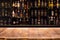 Empty wooden bar counter with defocused background and bottles of restaurant