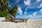 Empty wooden beach chairs on the tropical beach, vacation. Traveler dreams concept