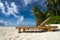 Empty wooden beach chairs on the tropical beach, vacation. Traveler dreams concept