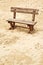 Empty wooden bench on the beach in cloudy weather