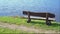 Empty wooden bench with blue sea view