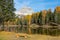 Empty wooden bench faces the breathtaking Lago d\\\'Antorno and the Dolomites