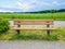 Empty wooden bench on green meadows