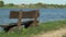 Empty wooden bench with lake view