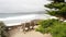 Empty wooden bench, rest on footpath trail. Ocean beach, California coast, trees