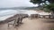 Empty wooden bench, rest on footpath trail. Ocean beach, California coast, trees