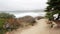 Empty wooden bench, rest on footpath trail. Ocean beach, California coast, trees