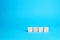 Empty wooden blocks on a blue background. Copy space, place for text and icons. Add numbers and letters. Blank for design, mockup
